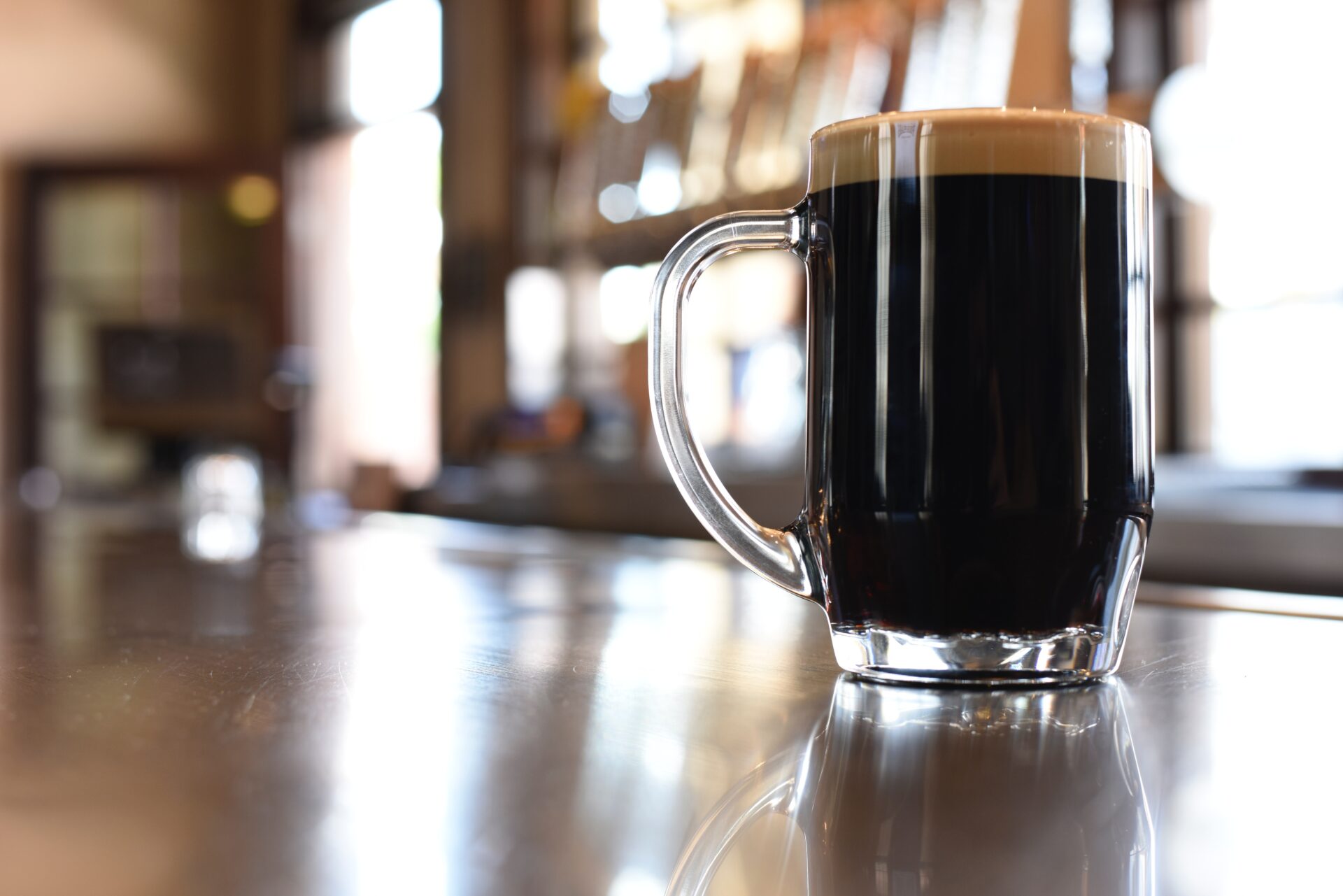 clear glass mug with black beer 