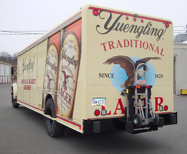 the truck is painted in beige with the emblem and the name of the beer: Yuengling Traditional Lager since 1829